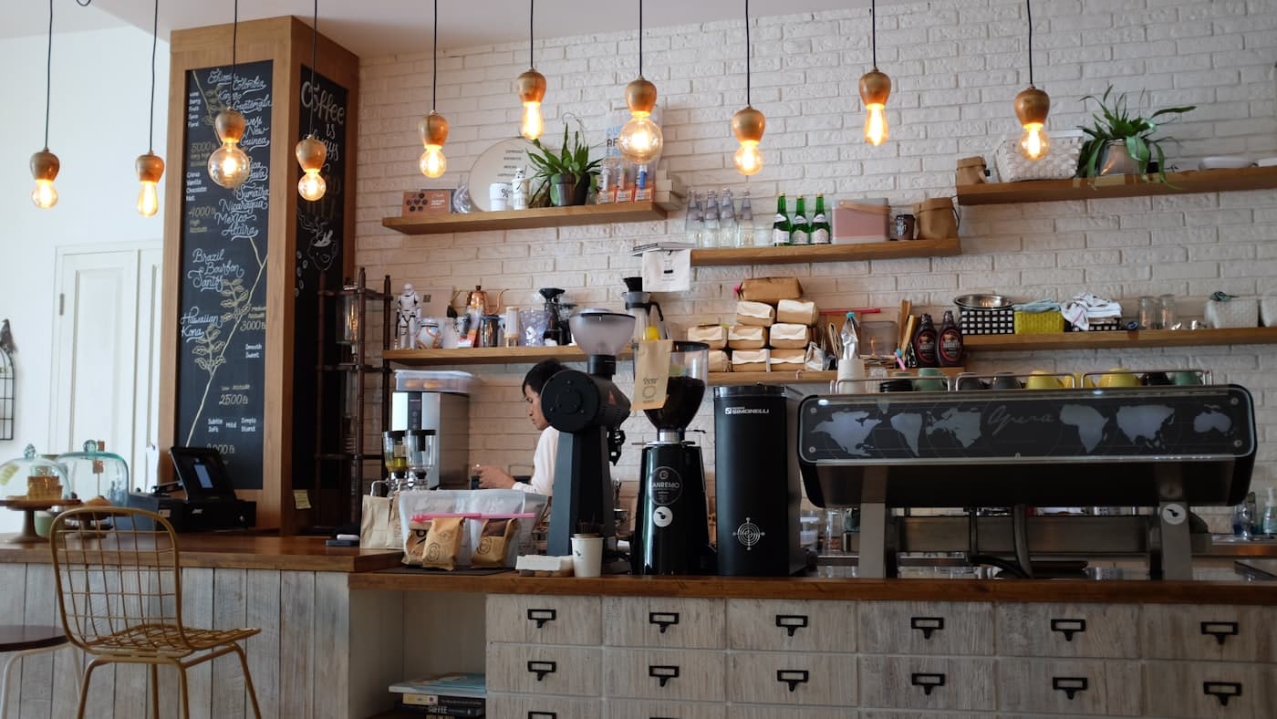 A warm neighborhood coffee shop with guests at the counter
